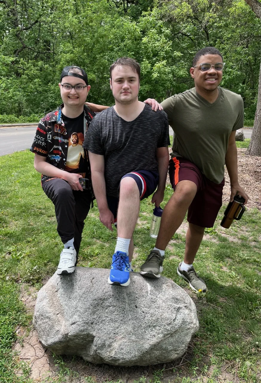 A group of young people looking at the camera and smiling